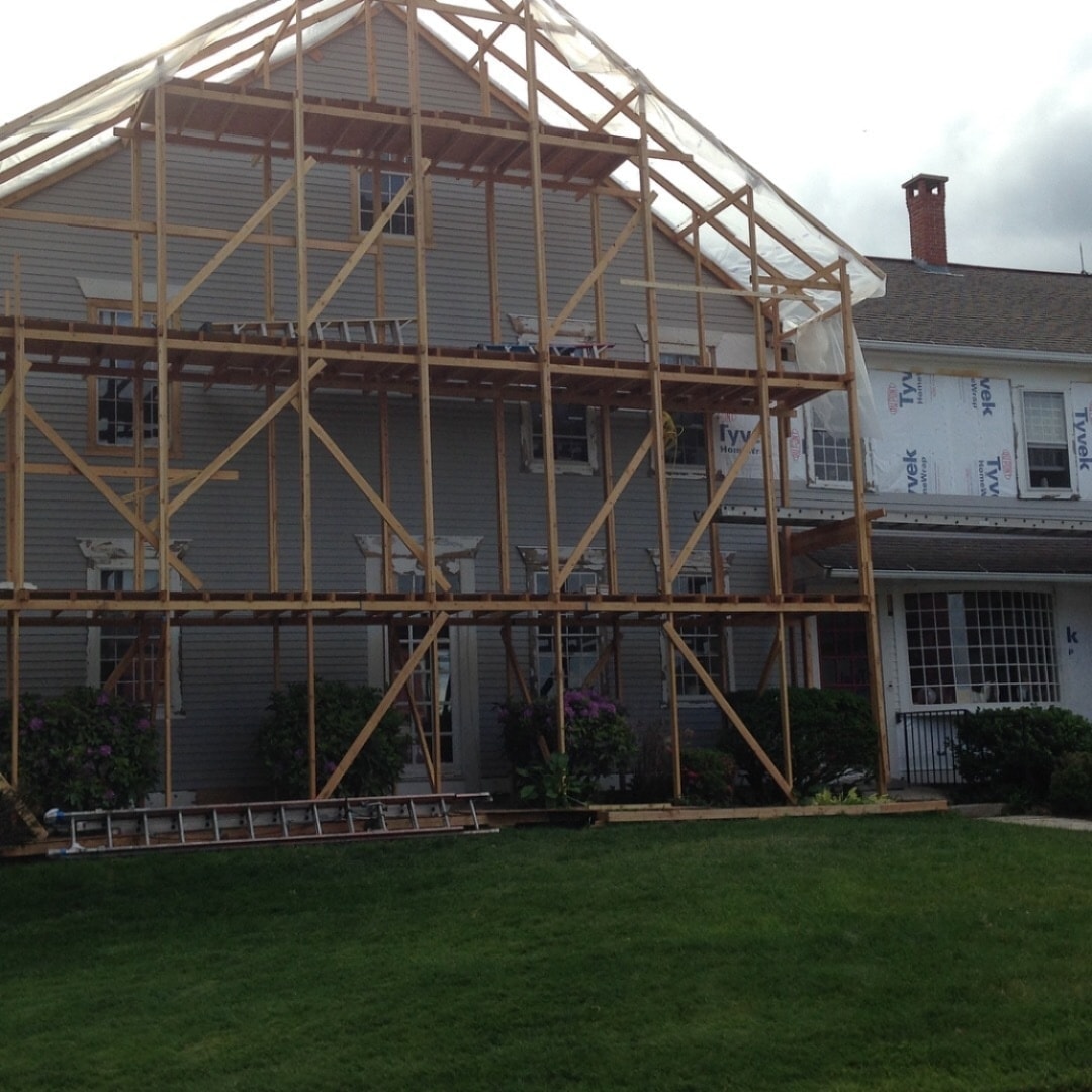 Scaffolding on a Connecticut home exterior renovation by Sunrise Construction