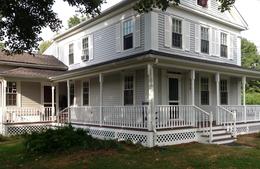 Victorian farmhouse exterior renovation with wraparound porch